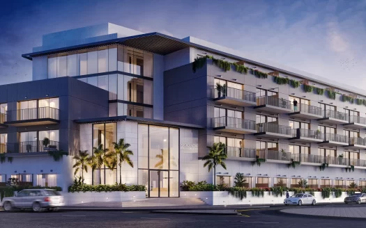 Immeuble d'appartements moderne à Dubaï au design élégant avec de grands balcons et balustrades en verre, entouré d'une verdure luxuriante, éclairé au crépuscule.