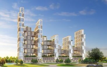 Bâtiments résidentiels futuristes à plusieurs niveaux dans un parc luxuriant avec un ciel clair à Dubaï. L'architecture présente un design cubiste empilé avec des balcons et des terrasses vertes.
