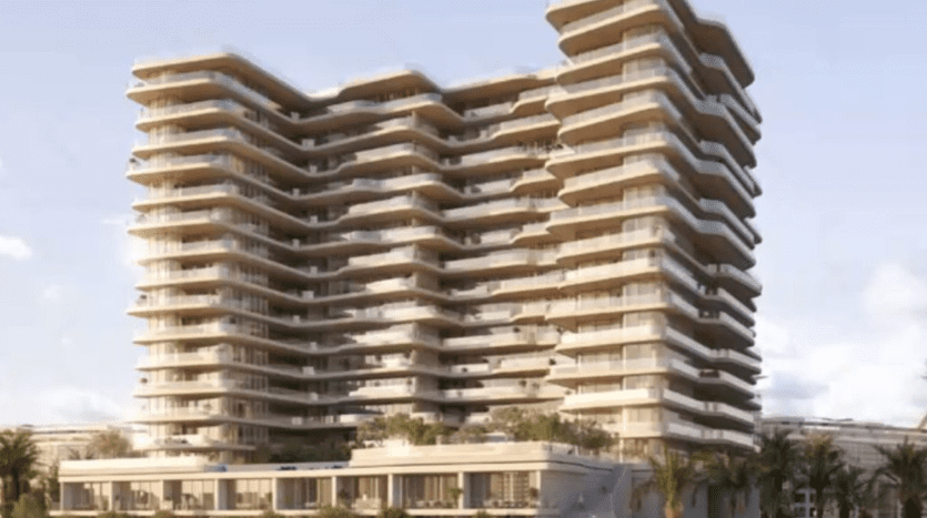 A modern multi-storey building with stacked terraced balconies, set under a bright sky, surrounded by lush greenery in Dubai.