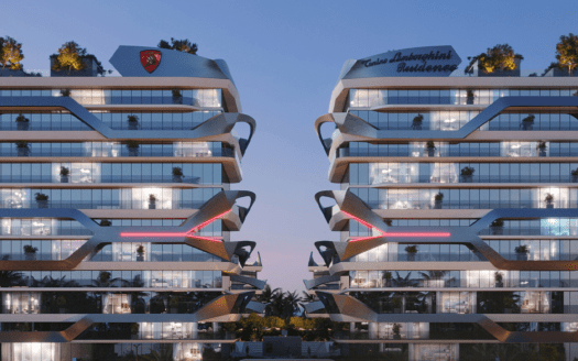 Deux bâtiments résidentiels modernes de plusieurs étages dotés de baies vitrées et de conceptions architecturales angulaires se côtoient, ornés de verdure sur leurs toits. Les deux bâtiments affichent bien en évidence sur leurs façades le label « Tonino Lamborghini Residences Dubai ». Le ciel est d'une teinte crépusculaire.