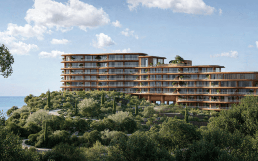Situé à flanc de colline, cet hôtel moderne de Dubaï présente une architecture élégante en panneaux de verre et de bois, entouré d'une végétation luxuriante. Surplombant la paisible baie d'Asora, il offre une vue imprenable sur l'océan sous un ciel partiellement nuageux.