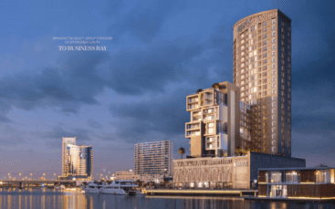Une vue panoramique en soirée sur le 15e quartier du front de mer du côté nord, avec des immeubles modernes de grande hauteur, avec un éclairage proéminent et une voie navigable calme reflétant les lumières de la ville.