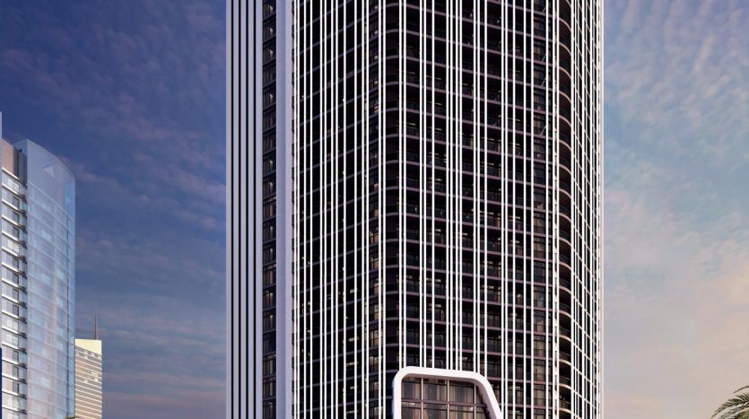 Un rendu architectural d'un immeuble futuriste de grande hauteur aux bords incurvés, avec une signalisation "Bayz" proéminente en haut et à la base, des piétons qui passent et un ciel bleu clair en arrière-plan.