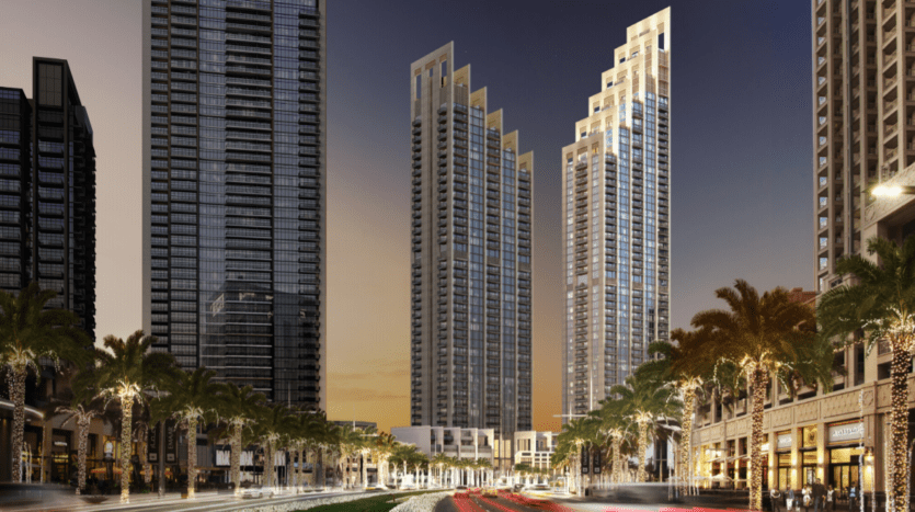 Une vue panoramique de Blvd Heights à Dubaï au crépuscule, mettant en valeur de grands gratte-ciel aux fenêtres éclairées et une rue animée aux feux de circulation flous.