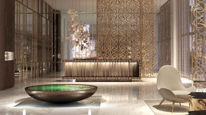 Hall d'entrée luxueux avec des accents dorés opulents, un grand bol décoratif au centre et un mobilier moderne et élégant d'Elie Saab, mettant en valeur une conception architecturale et un éclairage sophistiqués.