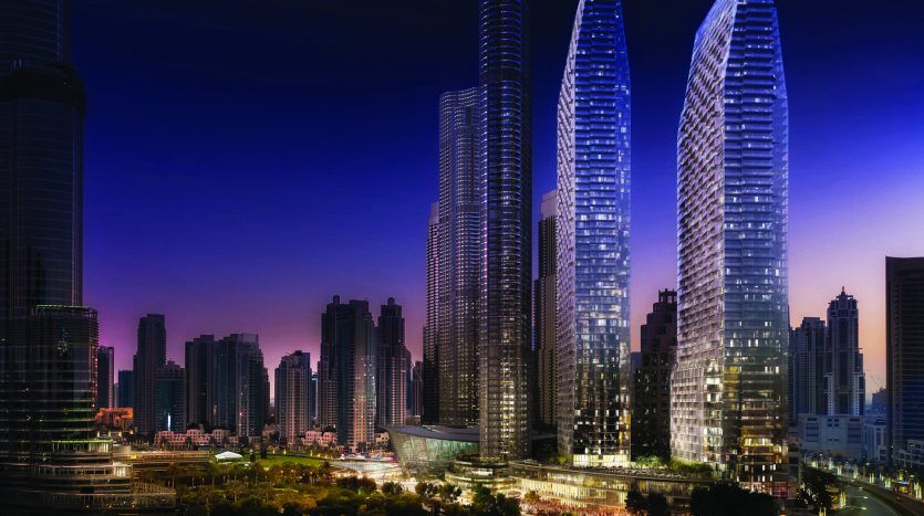 Paysage urbain nocturne avec des gratte-ciel illuminés aux designs modernes et élégants sur un ciel sombre dans un cadre urbain près de l'Address Residences Dubai Opera.