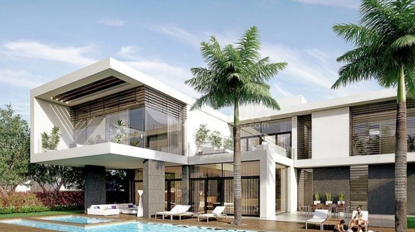 Une villa moderne et luxueuse dans le District Un avec de grandes fenêtres en verre, des détails architecturaux géométriques, entourée de palmiers luxuriants, dotée d'une piscine avec chaises longues et deux personnes se relaxant.