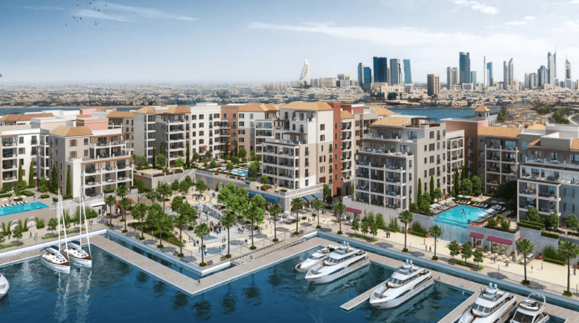 Une vue panoramique d'un luxueux quartier résidentiel en bord de mer à La Voile Port de la Mer, avec des bâtiments modernes, des piscines, une marina avec des yachts, une verdure luxuriante et un fond de