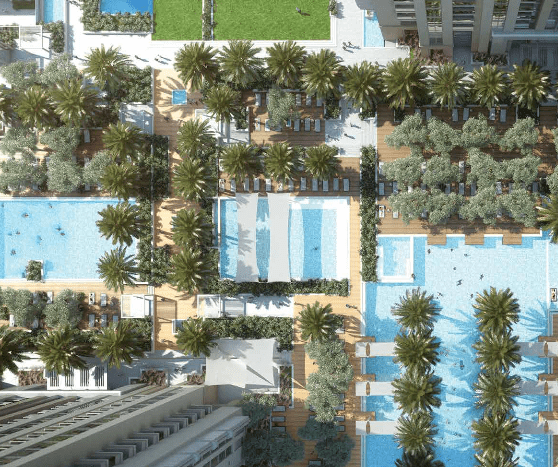 Vue aérienne de la tour Amna dans la ville d'Al Habtoor, comprenant un complexe hôtelier de luxe avec plusieurs piscines, des palmiers luxuriants et des bains de soleil sur les ponts, entourés de hautes