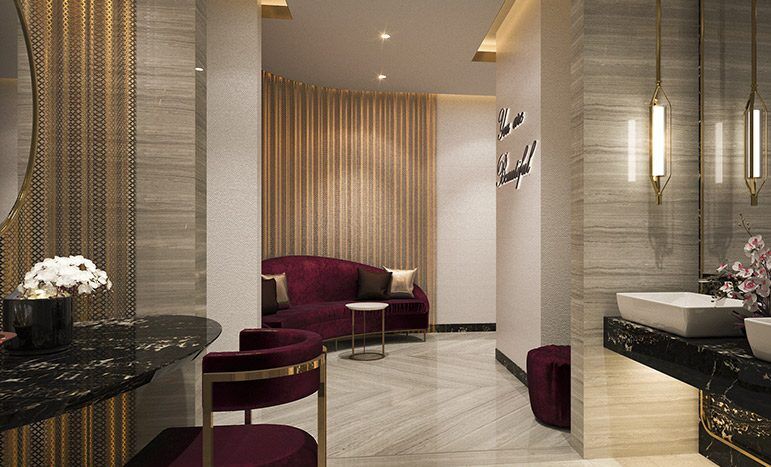 Un hall d'entrée luxueux avec des sols en marbre, des sièges en velours moelleux aux accents violet foncé et dorés, des luminaires élégants et des rideaux drapés à Kiara Damas Hills, créant une atmosphère sophistiquée et accueillante.