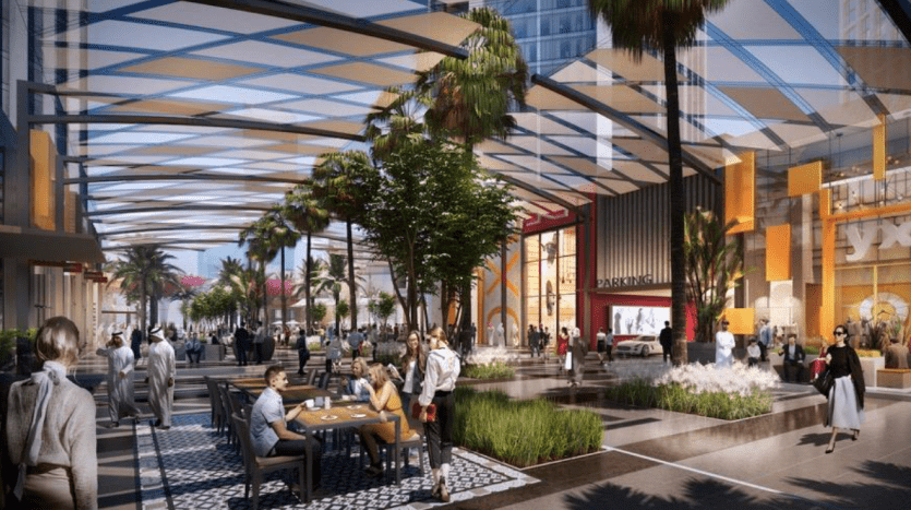 Une représentation artistique d'une zone commerçante dynamique en plein air sur la péninsule de Dubaï, avec une verrière moderne, de nombreux acheteurs et convives assis à des tables entourées d'une verdure luxuriante et de vitrines élégantes.