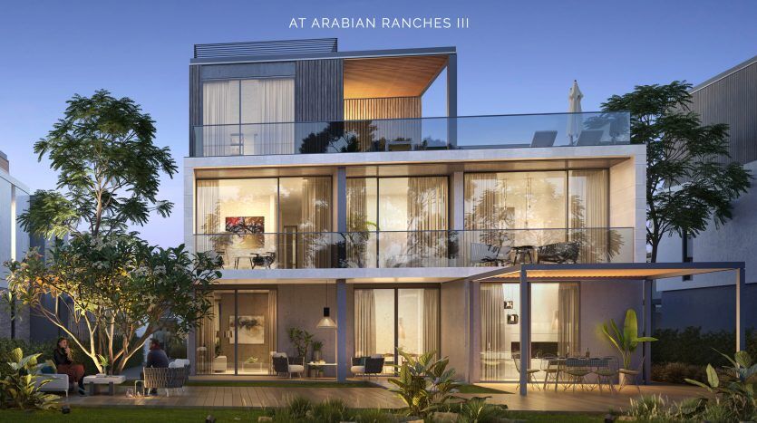 Une luxueuse maison à plusieurs niveaux au crépuscule, dotée de vastes façades en verre, d'une architecture moderne et d'espaces de jardin luxuriants, baptisée « Elie Saab à Arabian Ranches III ».