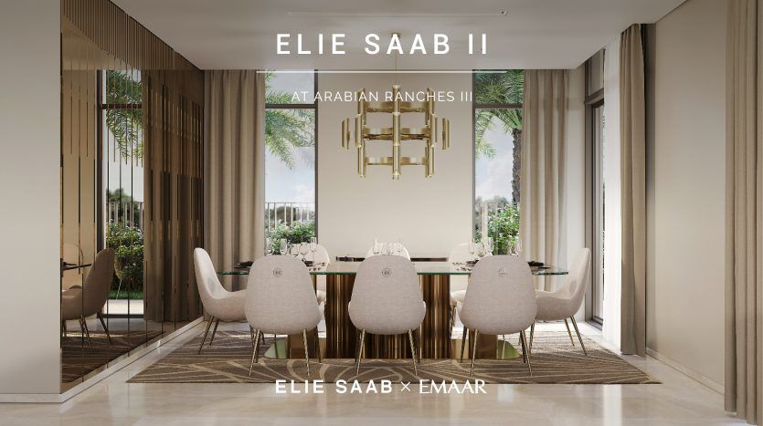 Salle à manger moderne avec une grande table pour six personnes, agrémentée de chaises moelleuses et d'un lustre géométrique, encadrée par des fenêtres panoramiques donnant sur la verdure. Le texte lit "Elie Saab II chez Arabian