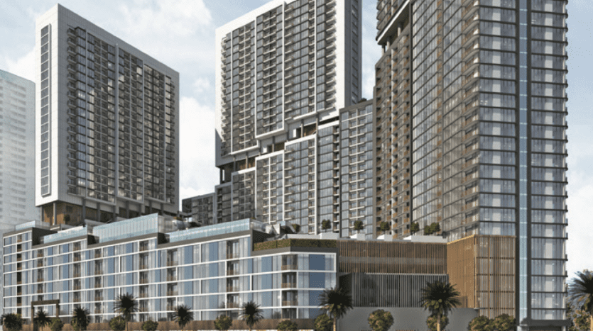 Immeubles modernes en bord de mer à The Crest Dubai avec des façades en verre réfléchissantes et des balcons donnant sur une rivière calme, entourés d'une verdure luxuriante et d'un ciel clair.