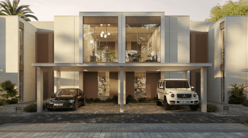 Immeuble résidentiel moderne à Talia la Vallée au design symétrique, caractérisé par une entrée centrale transparente, flanquée de murs texturés, sous un grand surplomb plat abritant deux voitures. Verdoyant