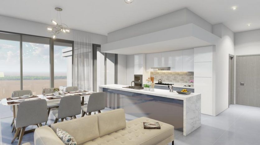 Cuisine et salle à manger modernes et spacieuses avec un long îlot, un éclairage contemporain et de grandes fenêtres avec vue sur la campagne. Un mobilier élégant dans des tons neutres complète le look, rappelant celui de Catch Dubai.