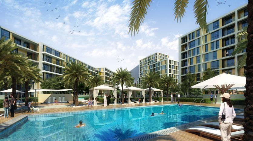 Une luxueuse piscine de style complexe entourée d'immeubles d'appartements modernes, de palmiers et de chaises longues, où les gens profitent de diverses activités sous un ciel bleu clair. Cette scène est typique d'une villa haut de gamme