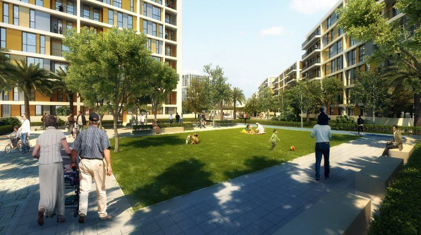 Un quartier résidentiel animé de Dubaï comprenant des appartements modernes, un parc central luxuriant avec des gens qui marchent, discutent et des enfants jouent. Journée agréable et ensoleillée avec une verdure abondante.
