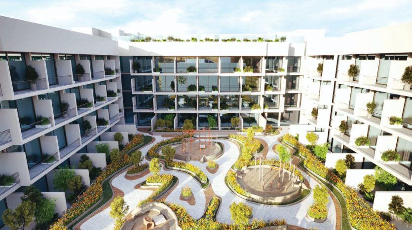 Vue aérienne d'un complexe résidentiel moderne à Dubaï avec des cours paysagées, des sentiers sinueux, des coins salons et une verdure luxuriante. Les bâtiments comportent plusieurs étages avec des balcons donnant sur les jardins