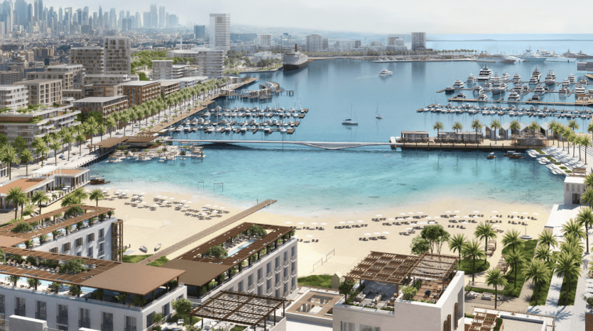 Vue aérienne d'une ville côtière moderne de Dubaï avec des gratte-ciel et une marina remplie de yachts, entourée d'une verdure luxuriante et d'une plage de sable menant à la mer bleu clair.