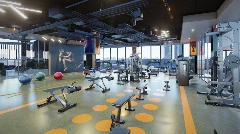 Une salle de sport moderne dans une villa de Dubaï avec divers équipements, notamment des tapis roulants, des vélos d'exercice, des appareils de musculation et des poids libres. Le sol présente des motifs circulaires colorés et de grandes fenêtres offrent une vue sur la ville.