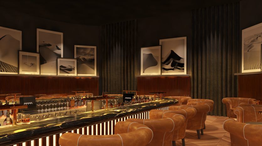 Un bar confortable et moderne avec un éclairage tamisé, doté d'un élégant comptoir noir, de chaises en velours et d'œuvres murales abstraites. L'ambiance est rehaussée par des tons chauds et sombres et un décor élégant qui reflète une inspiration de Dubaï.