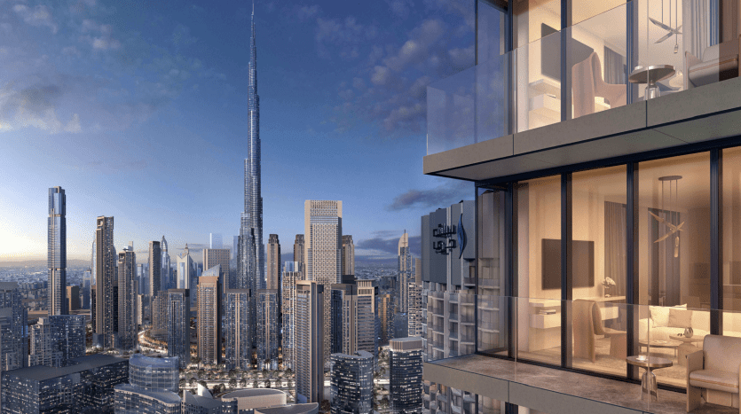Vue depuis le balcon d'un appartement de grande hauteur donnant sur un paysage urbain moderne de Dubaï au coucher du soleil, avec des gratte-ciel sous un ciel rose et une grande tour proéminente au loin.