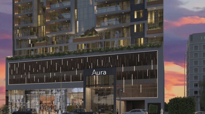 Une représentation artistique d'un bâtiment moderne nommé "aura" avec un mélange d'espaces résidentiels et commerciaux, dont l'appartement dubaï, magnifiquement éclairé au crépuscule avec une activité de rue animée.