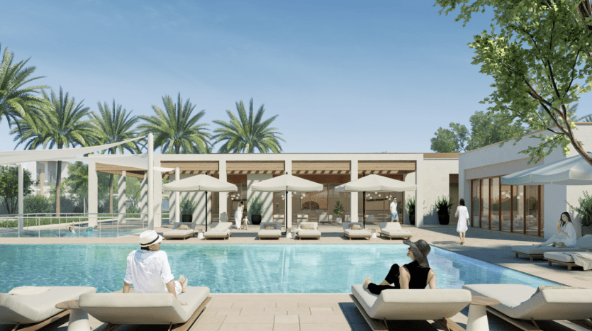 Espace piscine extérieure luxueuse dans un complexe d'appartements haut de gamme de Dubaï, avec des gens se relaxant sur des chaises longues sous des cabanes ombragées, entourées de palmiers et d'un ciel bleu clair.