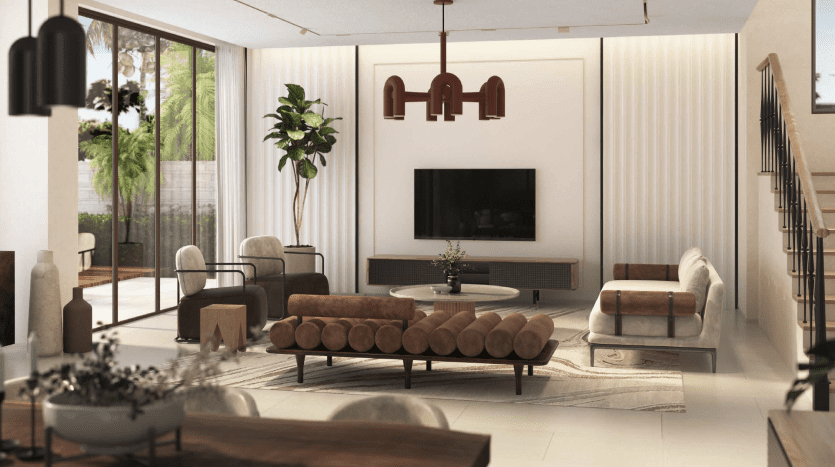 Salon moderne dans un appartement de Dubaï au design élégant comprenant une grande télévision murale, des canapés en cuir marron, une table basse ronde en verre et des suspensions. Les grandes fenêtres offrent suffisamment de lumière naturelle, améliorant