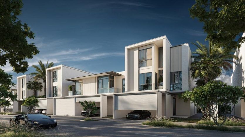Une rue résidentielle moderne de Dubaï comprenant des villas contemporaines à deux étages avec des toits plats et de grandes fenêtres. Chaque maison est complétée par une verdure luxuriante et une voiture de luxe garée dans l'allée.