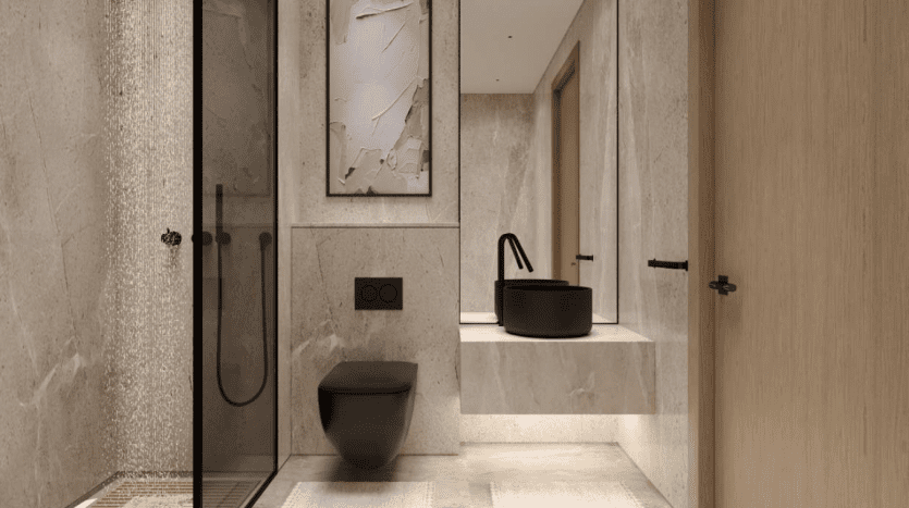Une salle de bains moderne dotée d'une élégante douche noire, de toilettes murales et d'un lavabo en marbre. Il y a des murs beiges, une porte vitrée et une œuvre d'art abstraite sur le mur provenant d'une entreprise agricole.