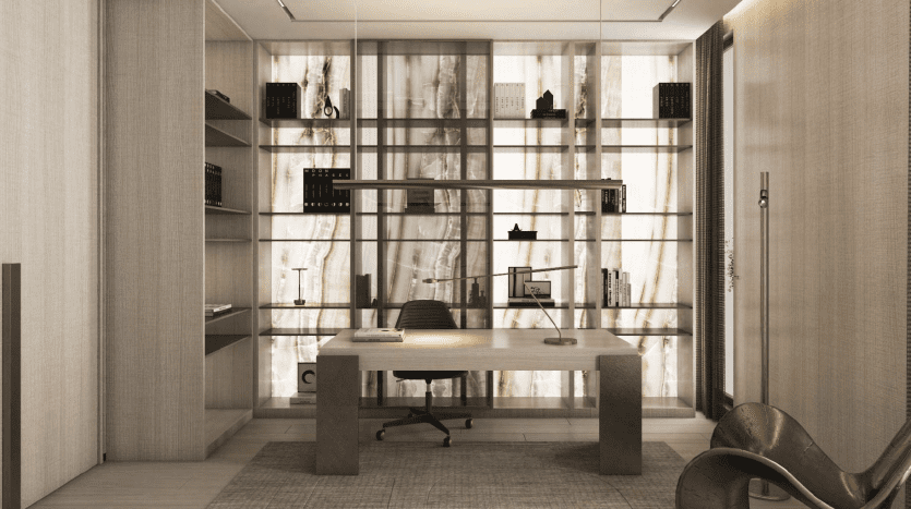 Un bureau élégant dans une pièce moderne comprenant un bureau en bois élégant, une chaise ergonomique et des étagères contre un mur en marbre texturé. L'éclairage ambiant et les éléments de design contemporain créent un espace de travail sophistiqué à Dubaï.