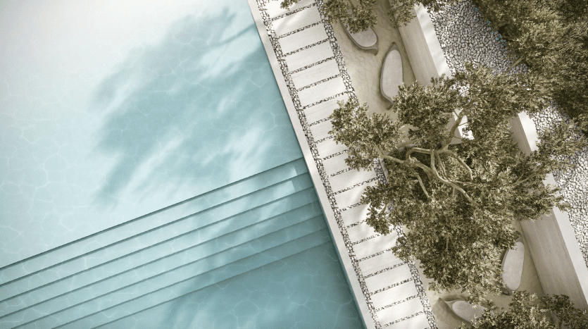 Vue aérienne d'une luxueuse piscine aux eaux turquoise à côté d'un patio carrelé blanc et d'un jardin décoratif avec des arbres matures et des allées de galets dans une villa Dubaï.