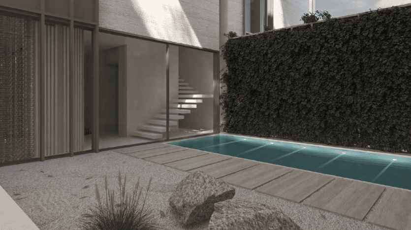 Conception architecturale moderne comprenant une piscine rectangulaire bordée de carreaux turquoise, entourée d'un jardin minimaliste avec des rochers et des buissons, sur fond de grands immeubles d'appartements élégants à Dubaï.