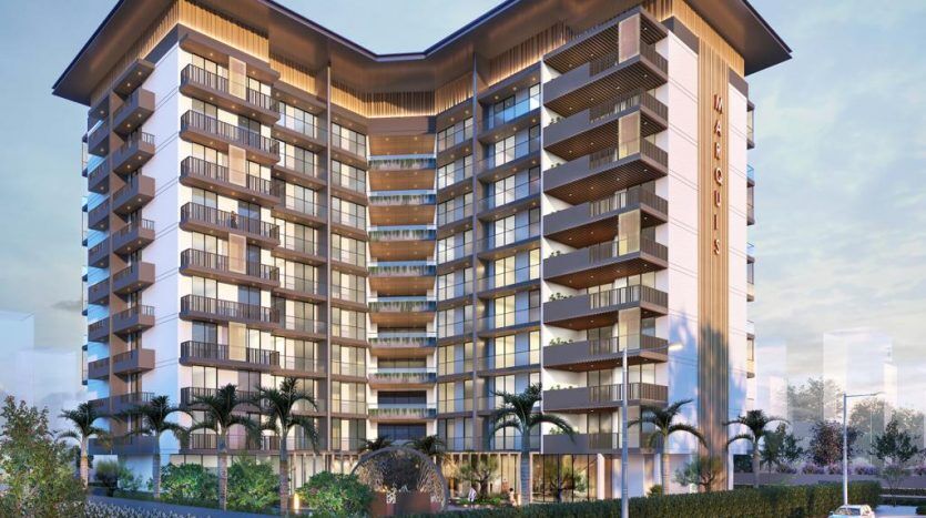 Un rendu artistique d'un immeuble résidentiel moderne de grande hauteur à Dubaï au crépuscule, avec une façade bien éclairée, entourée d'une verdure luxuriante et de voitures garées.