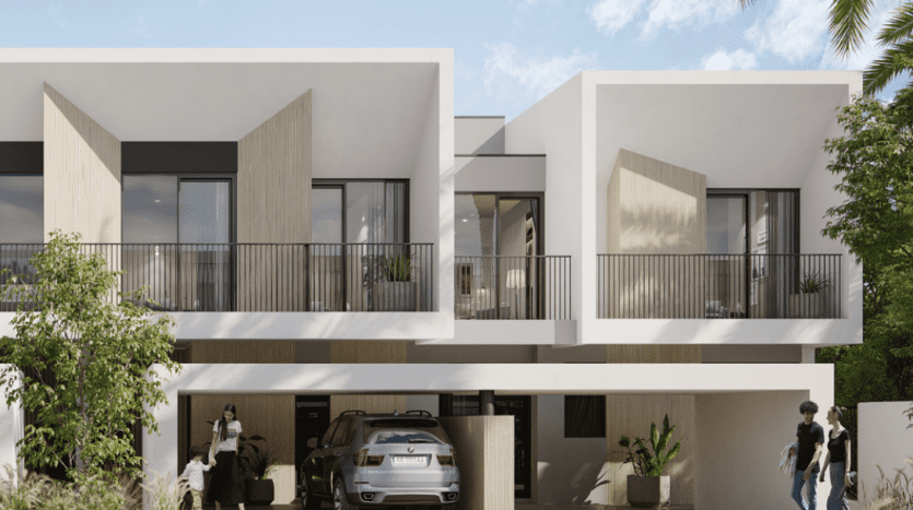 Bâtiments résidentiels modernes à Dubaï au design cubique, dotés de grandes fenêtres et de balcons. Les gens passent et interagissent à proximité de voitures garées et d’une verdure luxuriante.