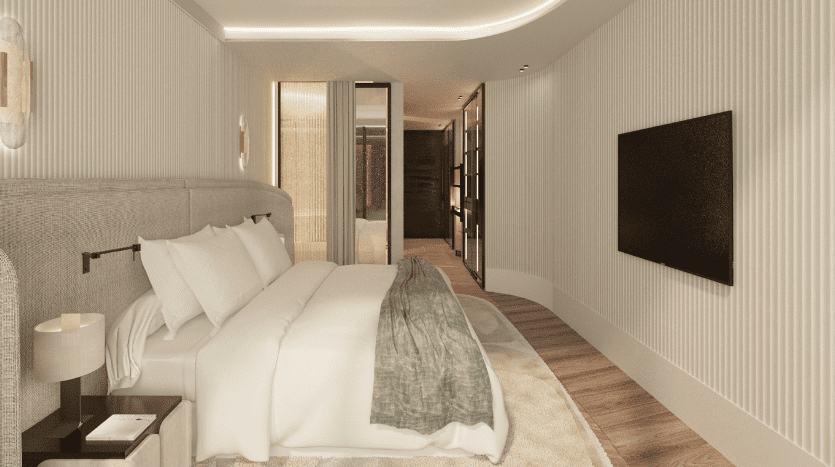 Une chambre confortable et moderne dans une villa de Dubaï comprenant un lit rembourré moelleux avec une literie blanche, une couverture verte, du parquet et un éclairage tamisé, avec une télévision à écran plat au mur et