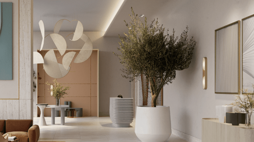 Eine moderne Eingangshalle mit großen Topfpflanzen, abstrakten Deckenleuchten, minimalistischen Möbeln und einer neutralen Farbpalette sieht man häufig in den gehobenen Wohnungen in Dubai.