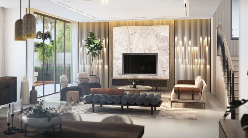 Un salon luxueux dans un appartement de Dubaï doté d'une grande cheminée en marbre, d'un mobilier moderne comprenant des canapés et des chaises, avec un éclairage élégant et des plantes vertes ajoutant chaleur et élégance.