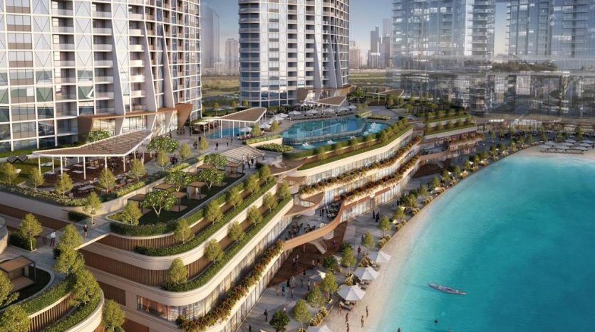 Luxurious beachfront residential neighborhood featuring modern high-rise buildings, lush terraced gardens, large swimming pool and sandy beach with people and kayak. Perfect for investment in Dubai.