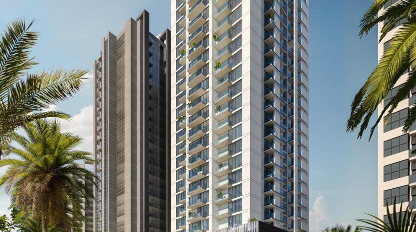 A modern high-rise building with architectural glass and sharp angles, surrounded by lush green palm trees under a clear blue sky, epitomizes luxury real estate in Dubai.