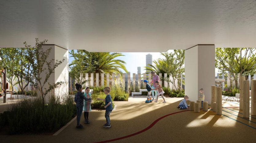 Children playing in a covered urban playground with greenery and modern sculptures, surrounded by tall Dubai villas in the background.