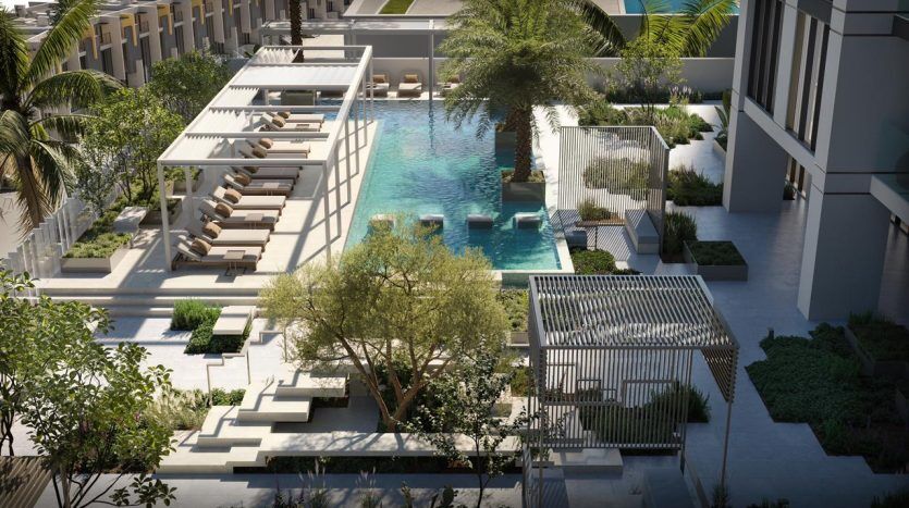 Aerial view of a modern outdoor pool surrounded by luxurious loungers, geometric garden spaces and elegant architectural elements in an urban Dubai real estate setting.