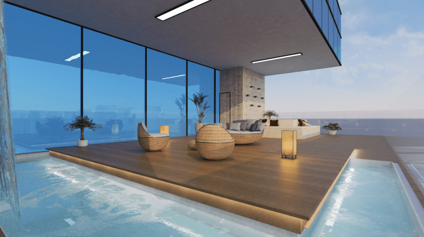 Espace piscine intérieure moderne avec un bord à débordement, des murs de verre donnant sur l'océan, des chaises en osier élégantes, un canapé et des plafonniers intégrés, créant un espace de détente serein dans une villa de Dubaï.