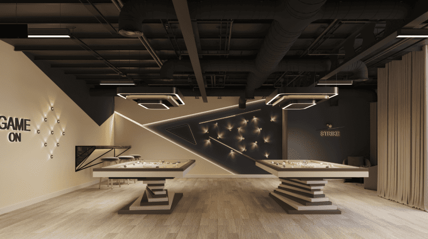 Un intérieur de salle de jeux moderne avec deux tables de baby-foot, des œuvres d'art murales abstraites et un éclairage spectaculaire dans une ambiance faiblement éclairée dans un appartement de Dubaï, avec un panneau « jeu activé » sur le