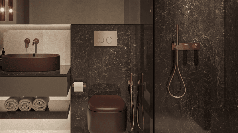 Une salle de bains luxueuse dotée d'un mur en marbre foncé avec un lavabo rond de couleur cuivre, une serviette assortie et un robinet. Des serviettes blanches soigneusement empilées et des luminaires modernes améliorent l'ambiance de cette villa de Dubaï.