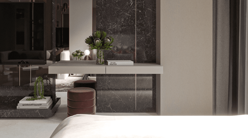 Une chambre moderne dans un luxueux appartement de Dubaï présentant un design élégant avec des murs en marbre, une étagère flottante blanche avec des livres et des plantes, un miroir rond et des tabourets rouges dans un petit coin bureau. Une peluche