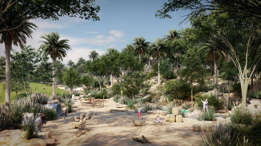 Un parc animé avec de grands palmiers, des allées sablonneuses et des gens profitant tranquillement du plein air au milieu d'une verdure luxuriante et de coins salons dispersés à proximité des luxueuses villas de Dubaï.