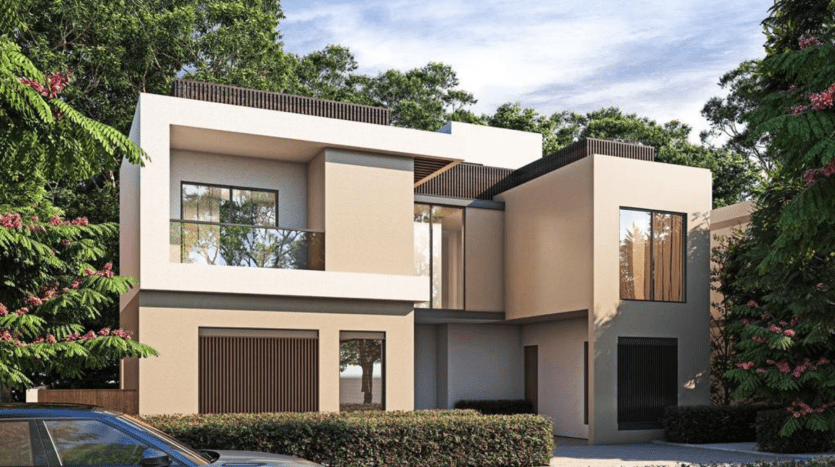 Une villa moderne de deux étages à Dubaï, présentant des extérieurs beiges et gris, de grandes fenêtres en verre et entourée d'une verdure luxuriante sous un ciel dégagé. Une voiture est garée devant dans l'allée.